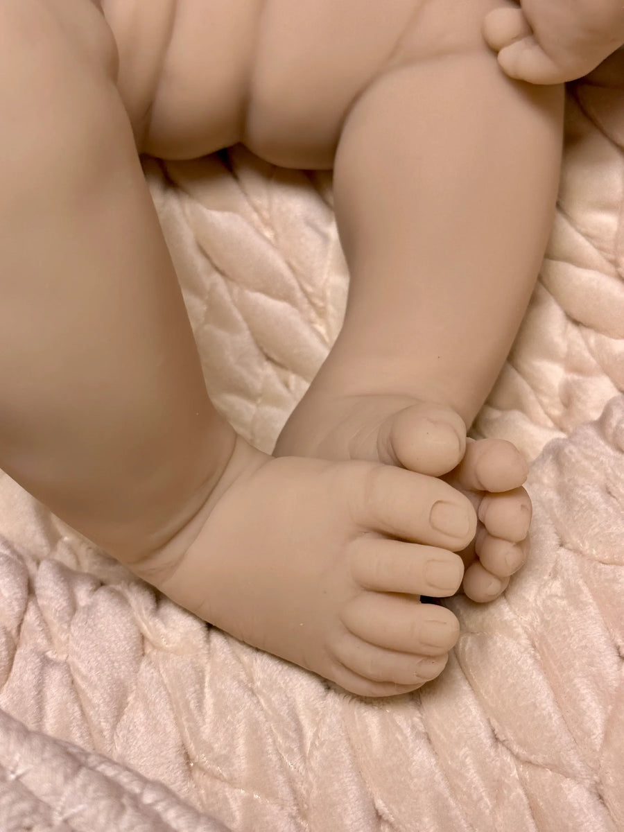 Close-up of a baby's feet on a soft textured surface